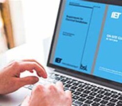 Learner reviewing the IET Wiring regulations on a laptop