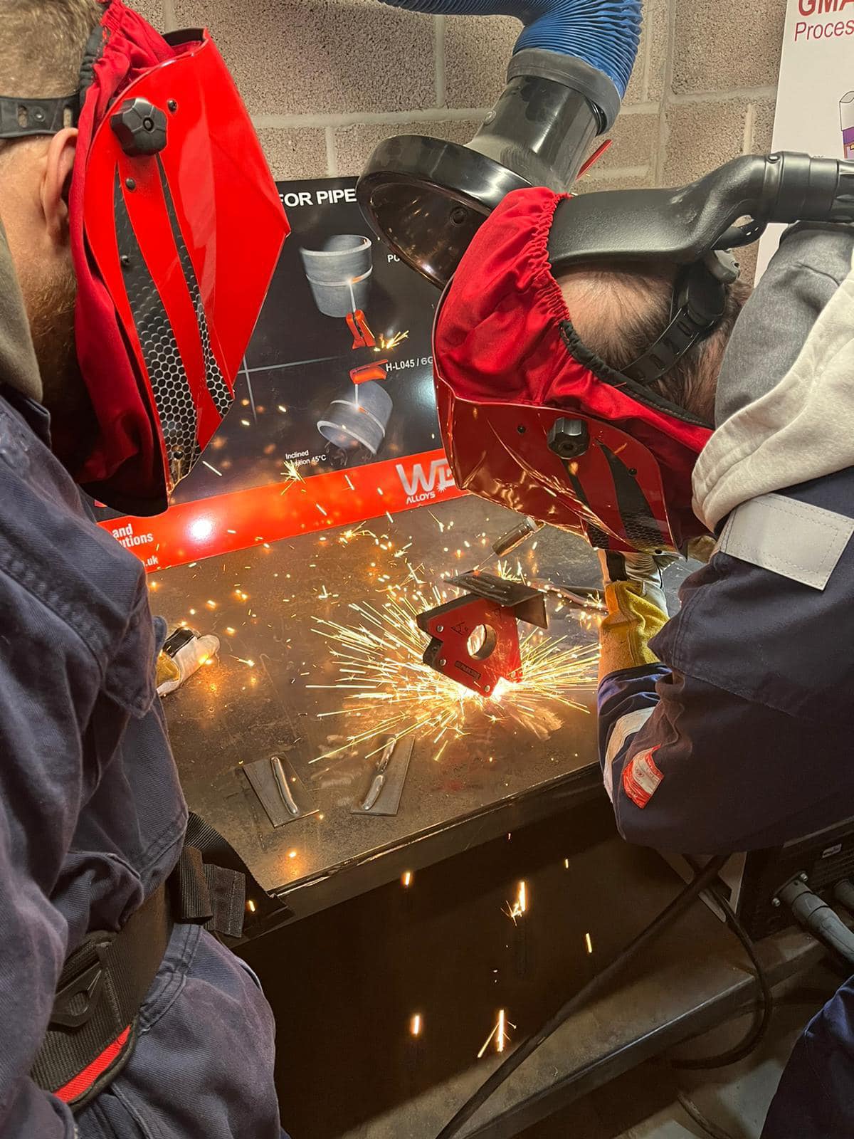 two males developing their welding skills