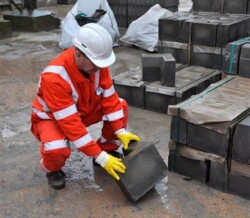 Picture of a man lifting blocks on site