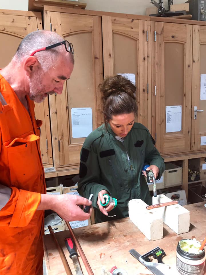 Picture of staff member learning how to solder during staff development day