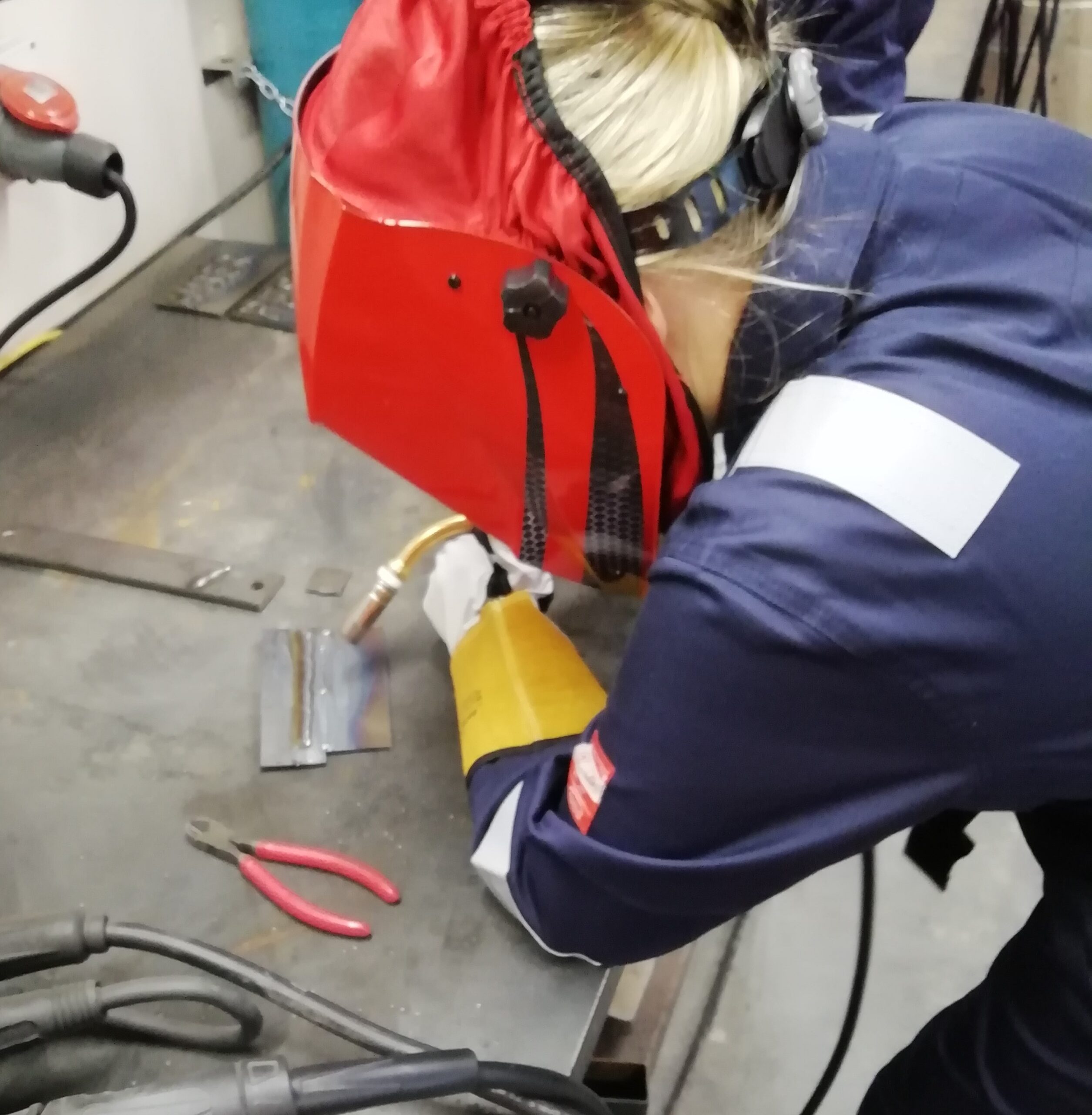 Female welding on a bench