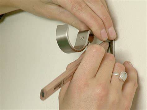 Picture of female putting up a curtain pole