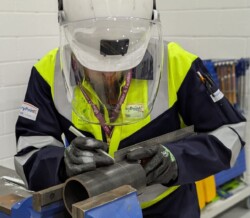 Man using a scribe on pipe